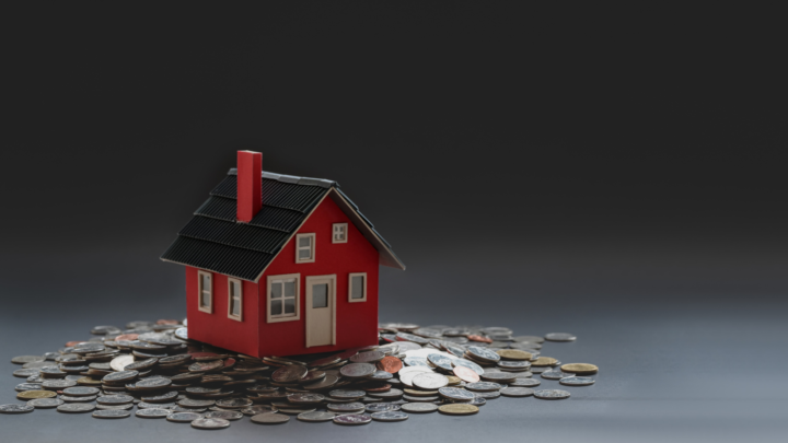 Stock image of model house on coins