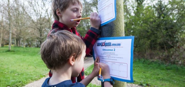 Two young children working on clues for Xplorer