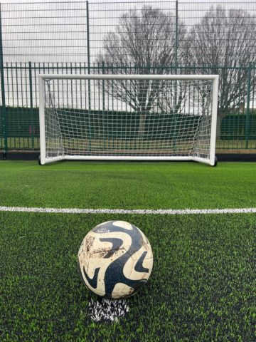 A football in front of a goal on the ATP at Abbey Sports Centre