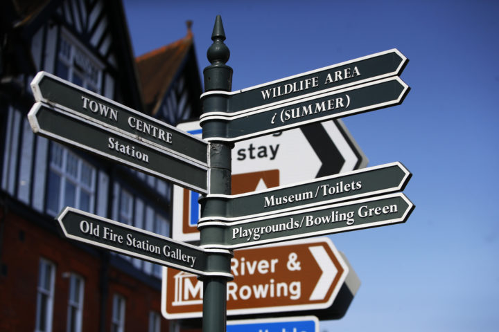 Image of community signage in Henley, with signs pointing to wildlife area, town centre, information centre, station, museum and toilets, old fire station gallery, playground and bowling green.